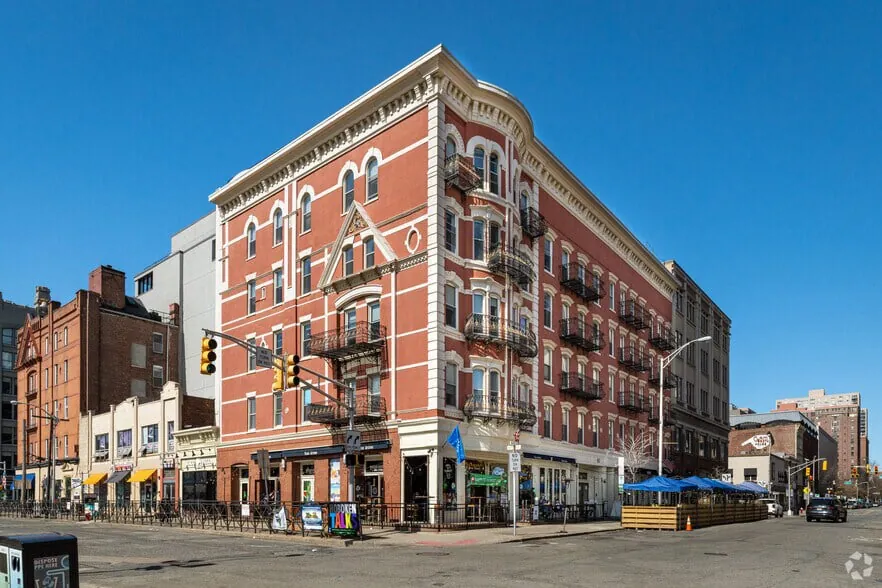 The red-brick building at 80 River Street on a Hoboken corner, a short walk from Hoboken Terminal.