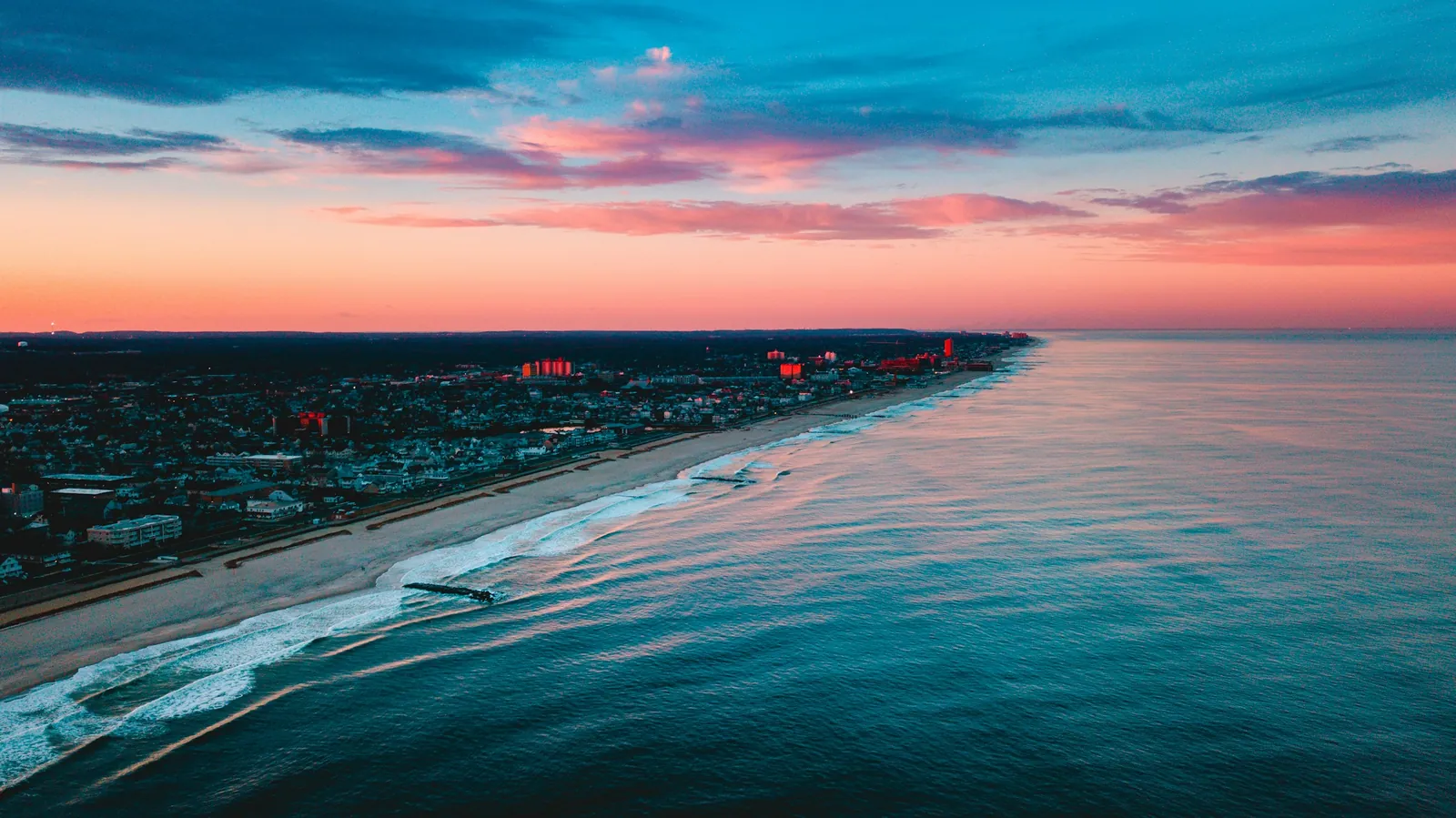 An aerial view of the Jersey Shore coastline and beach towns at sunset.